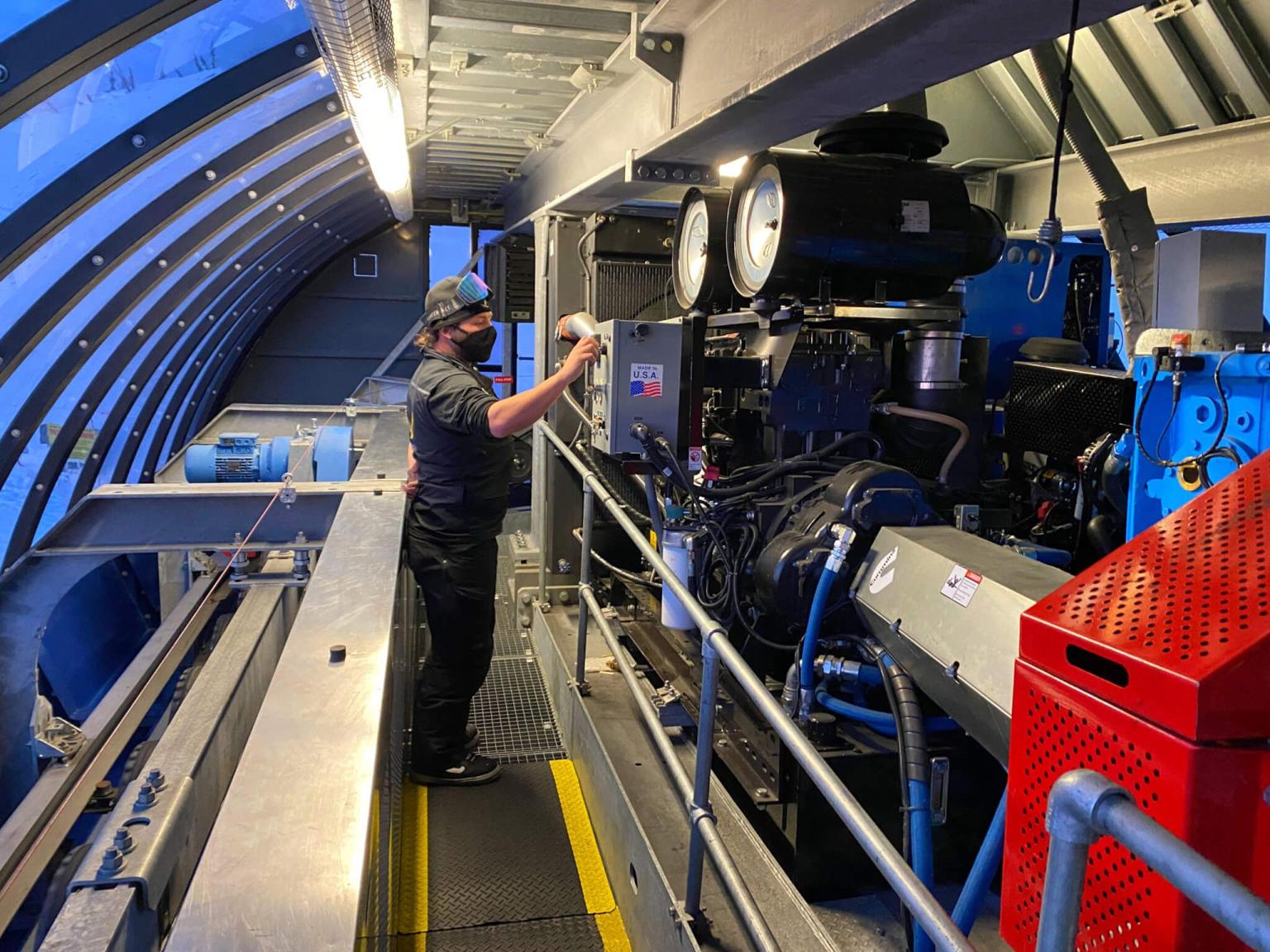 Person working on machine inside a ski lift